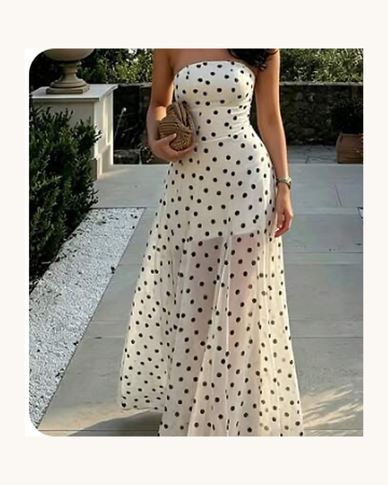 Model wearing a cream maxi dress with black polka dots.