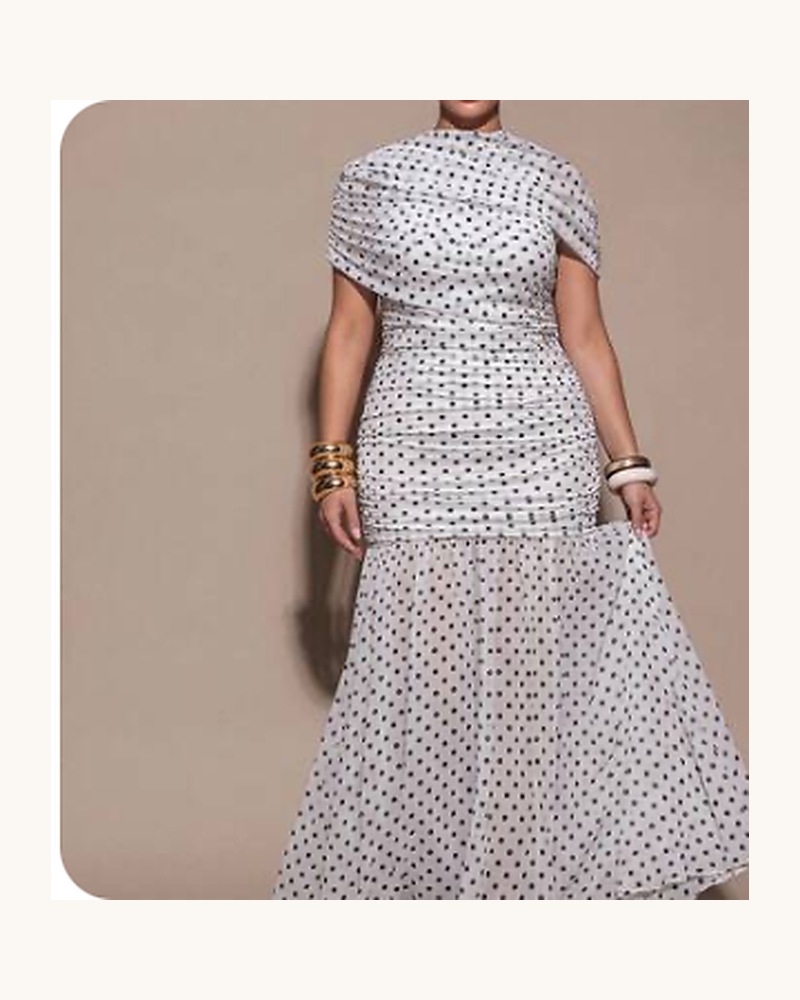 Curvy model wearing a black-and-white polka-dot fitted mermaid dress.