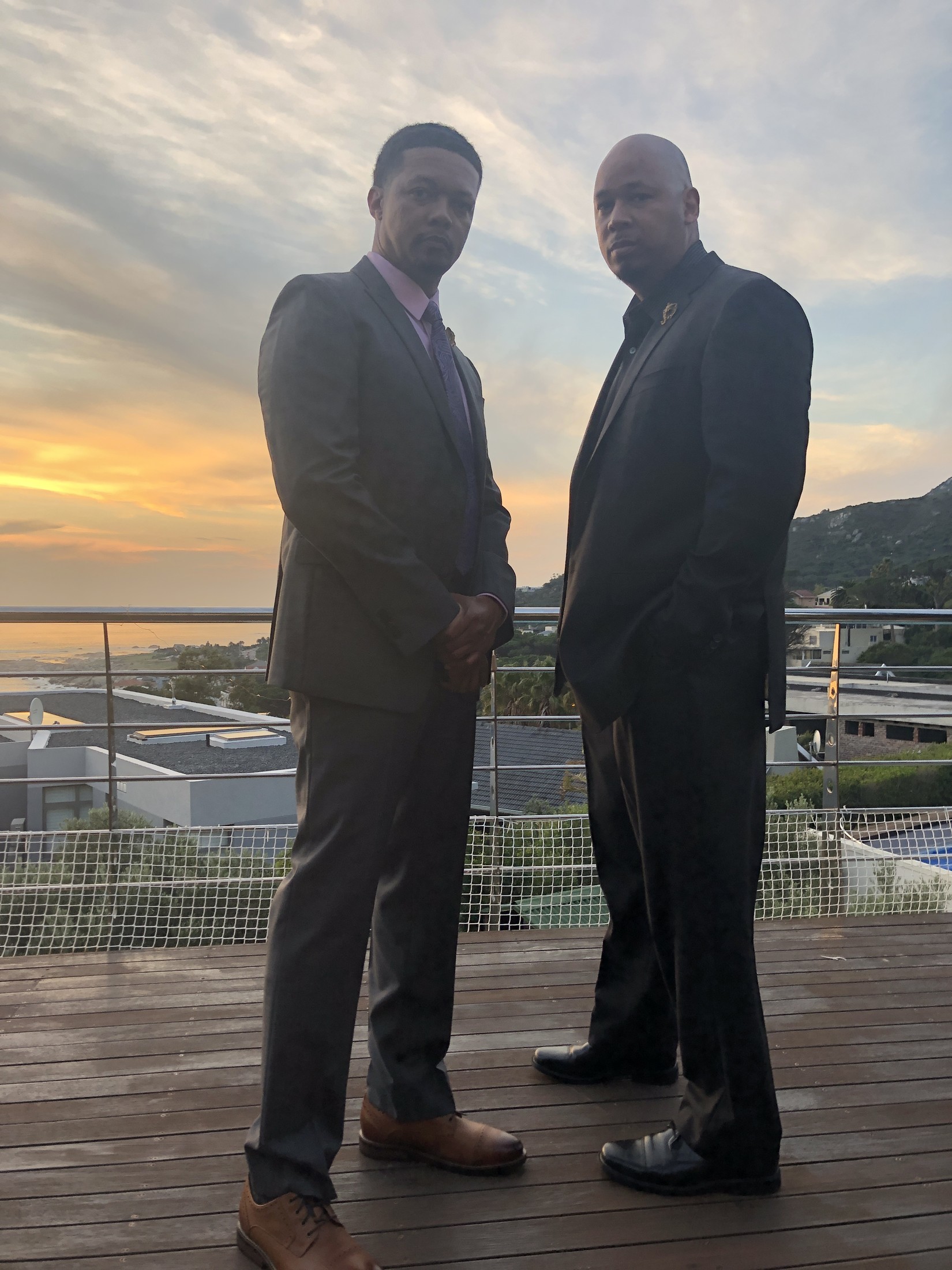 Two travelers silhouetted against a Cape Town sunset