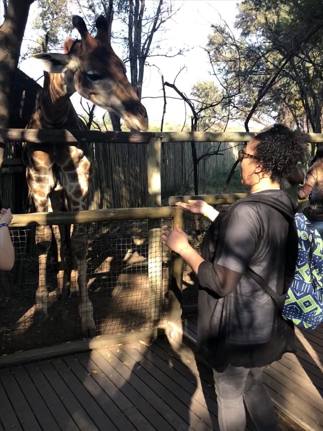 Sajuan Celestin meeting a giraffe during the 2019 South Africa trip