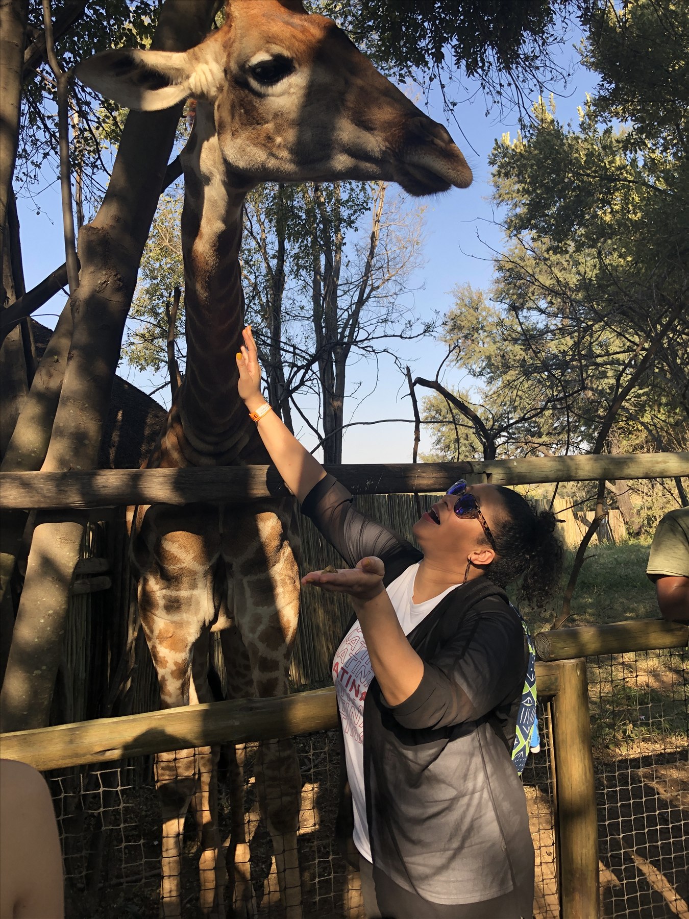 Sajuan Celestin feeding a giraffe during the 2019 South Africa trip